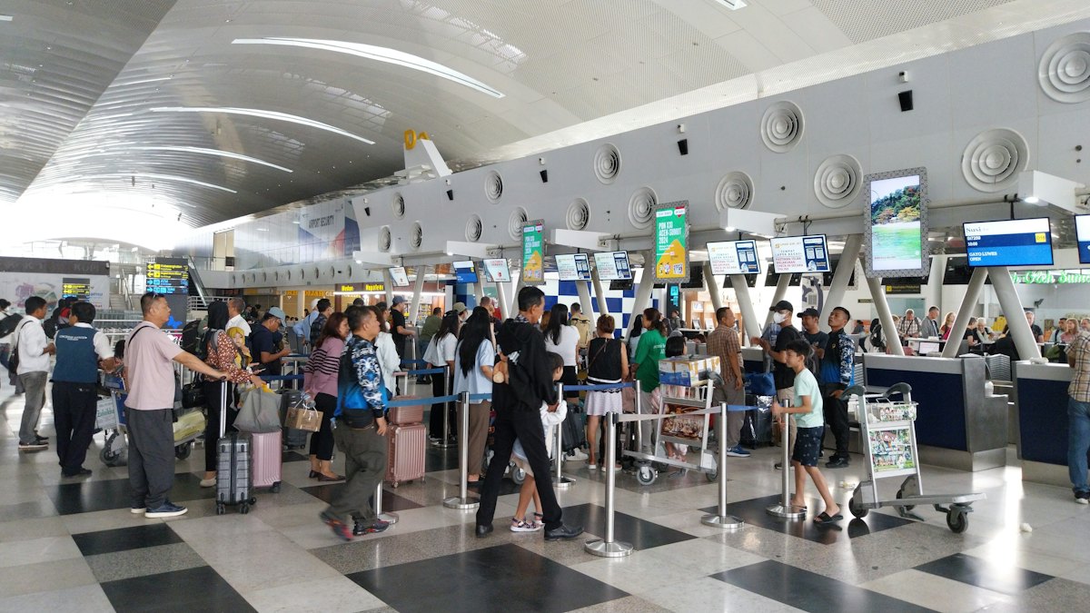 Passengers at an airport check-in hall