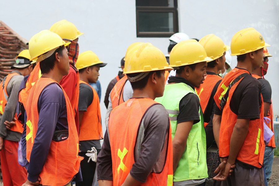 Workers in helmets attending a pre-departure orientation